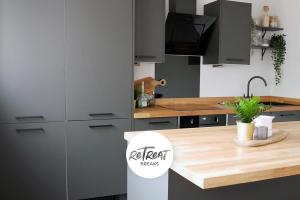 a kitchen with a wooden counter top in a room at ReTreat Breaks - 3 Bedroom Penthouse - Holbeck Leeds in Leeds