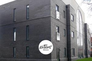 a brick building with a sticker on the side of it at ReTreat Breaks - 3 Bedroom Penthouse - Holbeck Leeds in Leeds