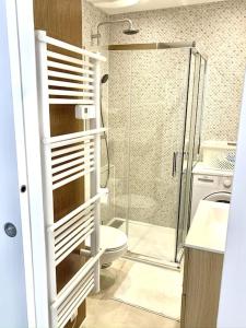 a bathroom with a toilet and a glass shower at Appartement Saint-Raphaël in Saint-Raphaël
