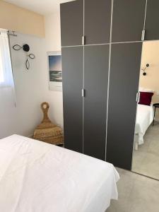 a bedroom with a bed and a large gray cabinet at Appartement Saint-Raphaël in Saint-Raphaël