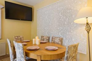 a dining room with a wooden table and chairs at Dublin Home by Clonsilla train 25min to City in Dublin