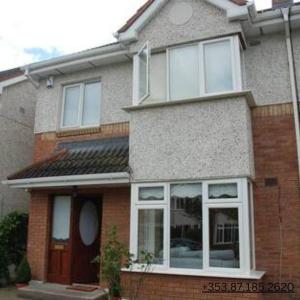 a brick house with large windows on the side of it at Dublin Home by Clonsilla train 25min to City in Dublin