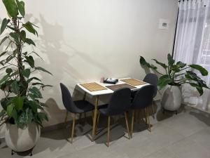 a table and chairs in a room with plants at 301 HomeVibes in Cali