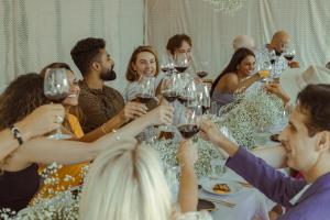 a group of people sitting around a table drinking wine at Merrill House in Picton