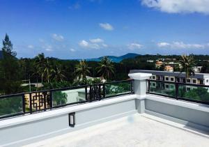 a balcony with a view of the mountains at Nature Pine Phuket เนเชอร์ไพน์ภูเก็ต in Rawai Beach