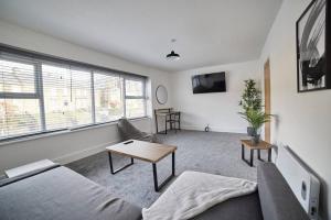 a living room with a couch and a table at High Spec Spacious 2BD Apt, Parking, Nr Newcastle in Gateshead