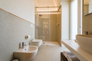 a bathroom with a sink and a toilet and a shower at HelloAPULIA Charming Palazzo Clemente - self-catering suites with aircondition in Monopoli