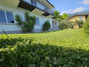 a house with a green lawn in front of it at CRISTOL 12 in Gargnano