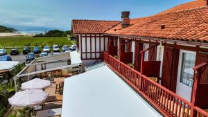 an aerial view of a house with a balcony and a parking lot at La Maison Uhabia in Bidart