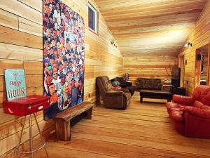 a living room with wood paneling and a large wall at Utopia Feels Botanical Glampground and Micro-Farm in Coldstream