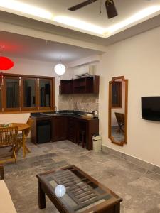 a kitchen and living room with a table in it at Villa Orchid Garden Riverside in Hoi An