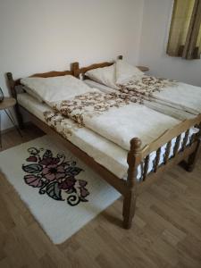 a bedroom with a bed with a white comforter at Barun apartman in Lusnić