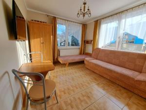 a living room with a couch and a table at Emides in Pobierowo