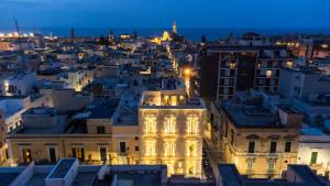 a view of a city at night at HelloAPULIA Charming Palazzo Clemente - self-catering suites with aircondition in Monopoli