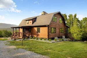 a large wooden house with a large yard at Riverside Rose Cabin: Luxe*LogCabin*MtnView*Sleeps12*Secluded*Shenandoah in Rileyville