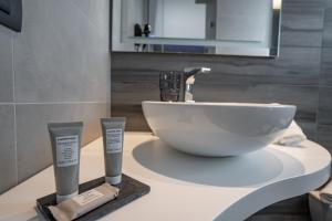 a bathroom with a sink and a white bowl at Hotel Ras in Gatteo a Mare