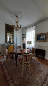 a living room with a dining room table and chairs at La Demeure d'Olympe in Haleine