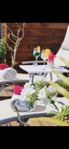 a table with flowers and wine glasses on it at Villa with pool close to the sea in Saint-Gilles les Bains