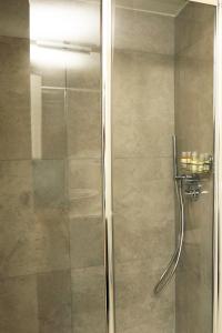 a shower with a glass door in a bathroom at Casa Bomma in Messina +23 photos