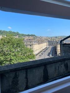 a view of a city from a window at The Great Pulteney Penthouse, Bath City Centre in Bath