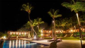 a resort with a pool and palm trees at night at Sunny Vacation Villa No 41 in San Rafael del Yuma