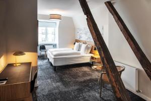 a hotel room with a bed and a desk at Jørgensens Hotel in Horsens