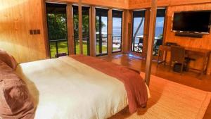 a bedroom with a bed and a large window at Sunny Vacation Villa No 41 in San Rafael del Yuma