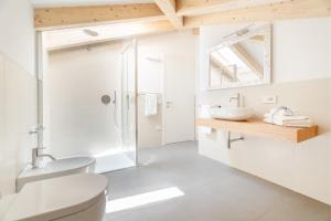 a bathroom with a toilet sink and a shower at Casa Al Sole in Tenno