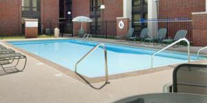 a large swimming pool with chairs around it at Best Western Plus Indianapolis North at Pyramids in Indianapolis