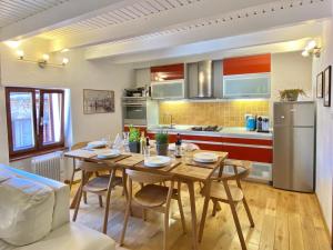a kitchen with a wooden table and a dining room at Romantic maisonette in Piran