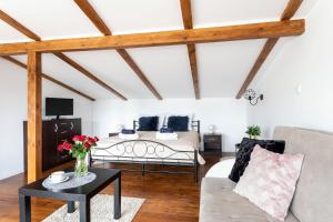 a living room with a bed and a table at Dolce Vita in Gdańsk