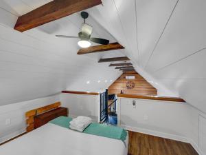 a attic bedroom with a bed and a ceiling at Cozy Island Cottage in Charleston