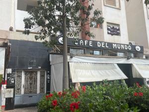 a building with a sign for a cafe del mundo at Appartement jad in Casablanca