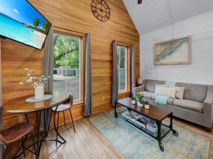 a living room with a couch and a table at Cozy Island Cottage in Charleston