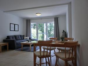 a living room with a table and chairs and a couch at Ferienwohnung NH12 in Hirschburg