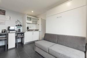 a living room with a couch and a kitchen at Casa Belvedere Egro - tiny house in Cesara +25 photos