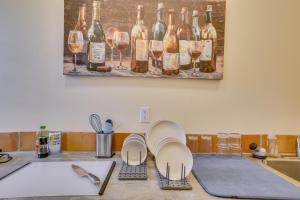 a kitchen counter with wine glasses and a sink at Cozy New Orleans Getaway Near Magazine Street! in New Orleans