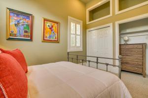 a bedroom with a white bed and a dresser at Cozy New Orleans Getaway Near Magazine Street! in New Orleans