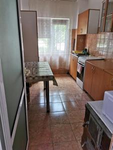 a kitchen with a table in the middle of it at La Bloc in Băile Herculane