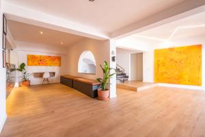 an empty living room with paintings on the walls at Hostal Alcina in Cala Ratjada