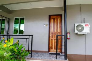 a front door of a house with a fan at MS Mountain Cabin in Loboc