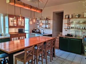 a kitchen with a large wooden table and chairs at Folwark Leszczynówka in Srebrna Góra