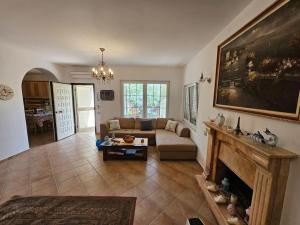 a living room with a couch and a fireplace at Golem Beach Villa in Golem +6 photos
