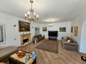 a living room with a couch and a fireplace at Golem Beach Villa in Golem