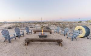 a group of chairs and a table with a candle at NEW PROPERTY! The Cactus Villas at Joshua Tree National Park - Pool, Hot Tub, Outdoor Shower, Fire Pit in Twentynine Palms