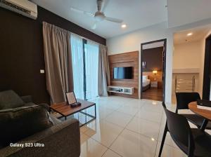 a living room with a couch and a table at Hotspring 1203 Studio Suite @ Sunway Onsen (4pax) in Tambun