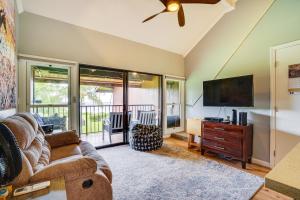 a living room with a couch and a flat screen tv at Kaunakakai Vacation Rental with Pool Access and A and C! in Kaunakakai