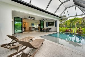 an external view of a house with a swimming pool at Contemporary Naples Home with Outdoor Kitchen and Pool in Naples