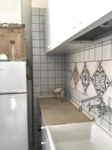 una cucina con lavandino e frigorifero bianco di Casa Annina a Gallipoli