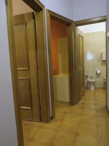 a bathroom with a toilet and a door open at Giglio Della Montagna in Livigno
